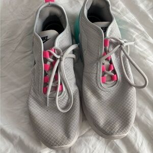 Nike Pink and White Athletic Shoes with Sleek Design